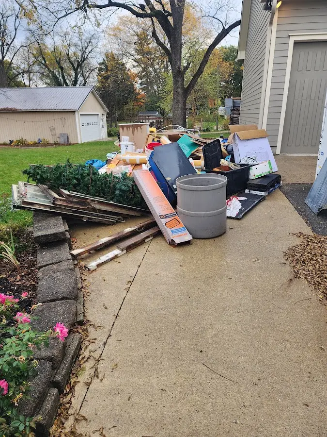 Dumpster being loaded with debris for Estate Cleanout Dumpster Rental in Duquesne
